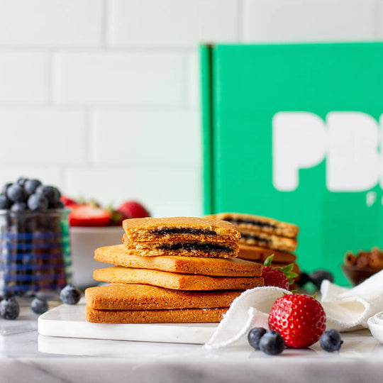 PBH Foods Toaster Pastries on a marble plate with a PBH Foods box in the background